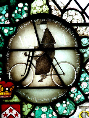 Stained glass roundal of the Canon Walter Herbert Marcon on his Bike in the church, Edgfield, Norfolk